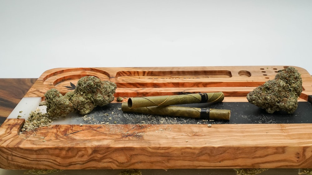 a knife and some broccoli on a wooden board