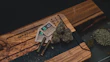 Stylish cannabis accessories displayed on a wooden table with natural light