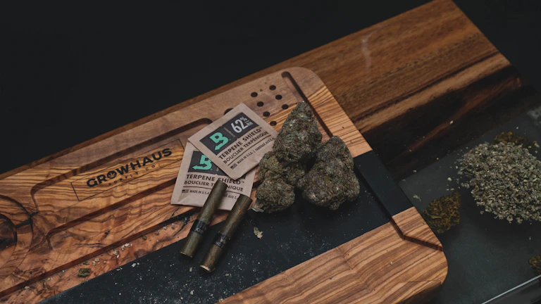 An assortment of cannabis products neatly arranged on a wooden table.