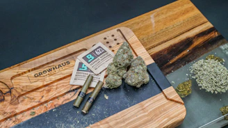 a group of marijuana on a cutting board