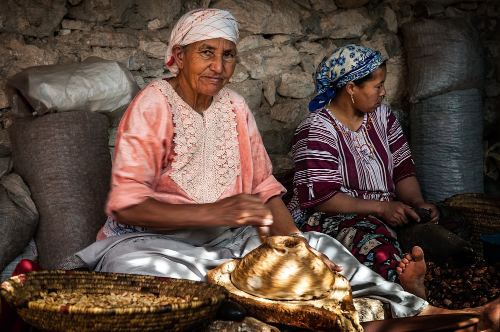 a man and a child sitting next to a basket of food