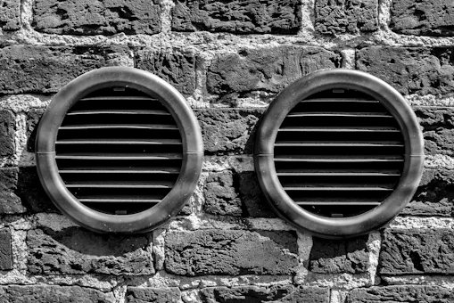 a couple of tires on a brick wall