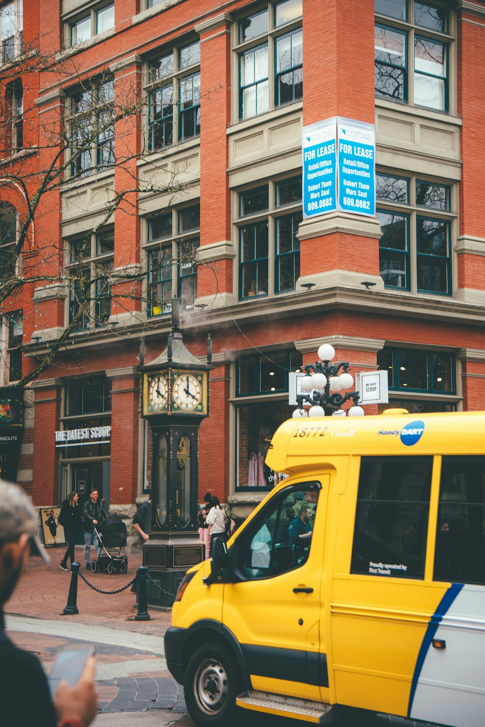 a yellow van parked in front of a brick building