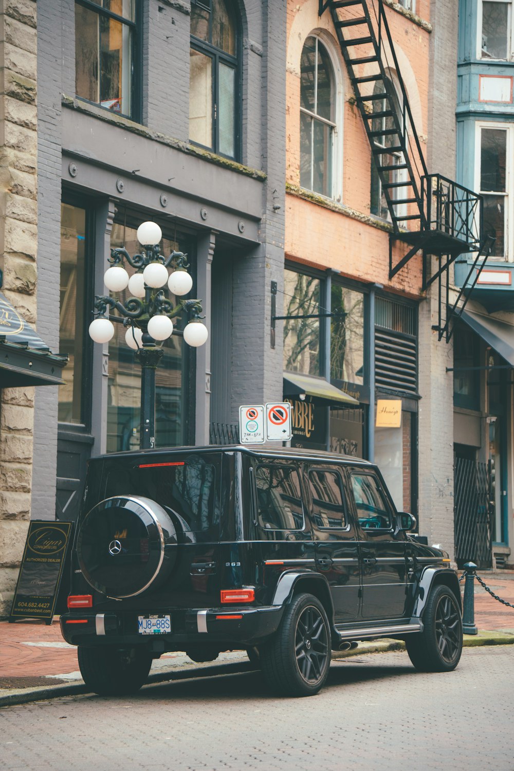 a black car parked on the side of a street