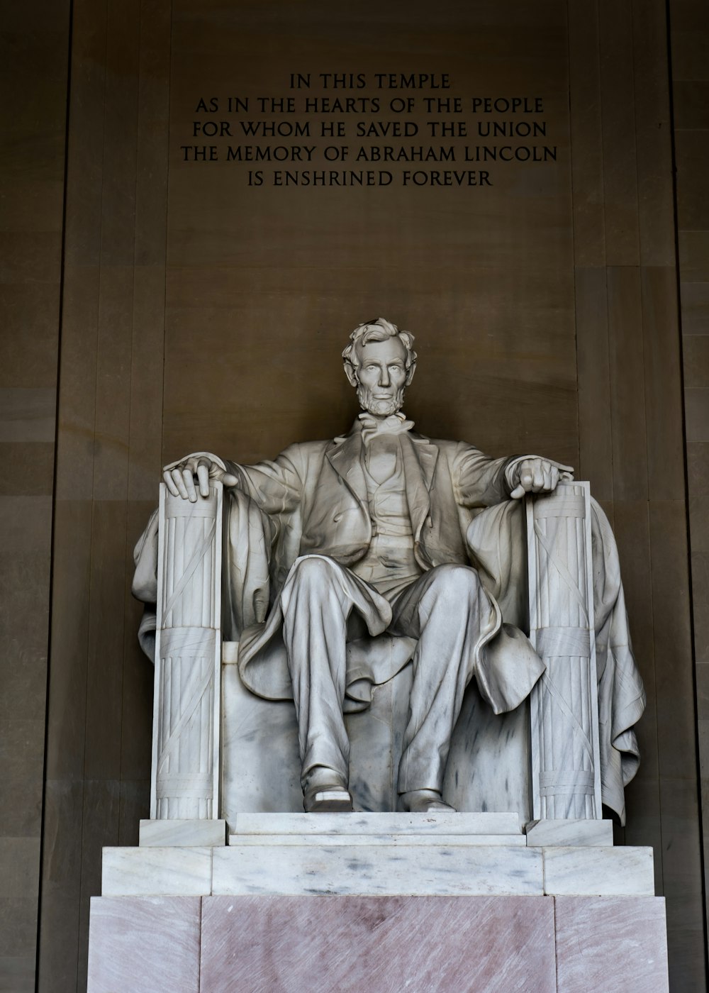 a statue of a person with Lincoln Memorial in the background