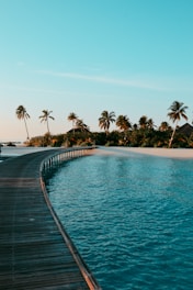a long dock leading to a beach