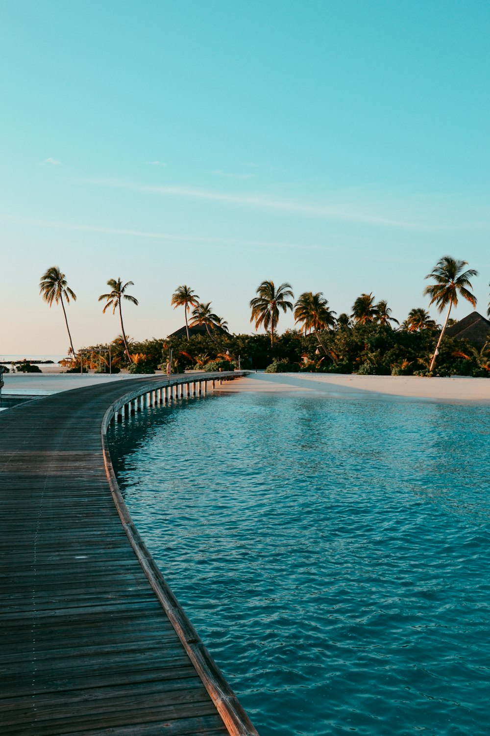 a long dock leading to a beach