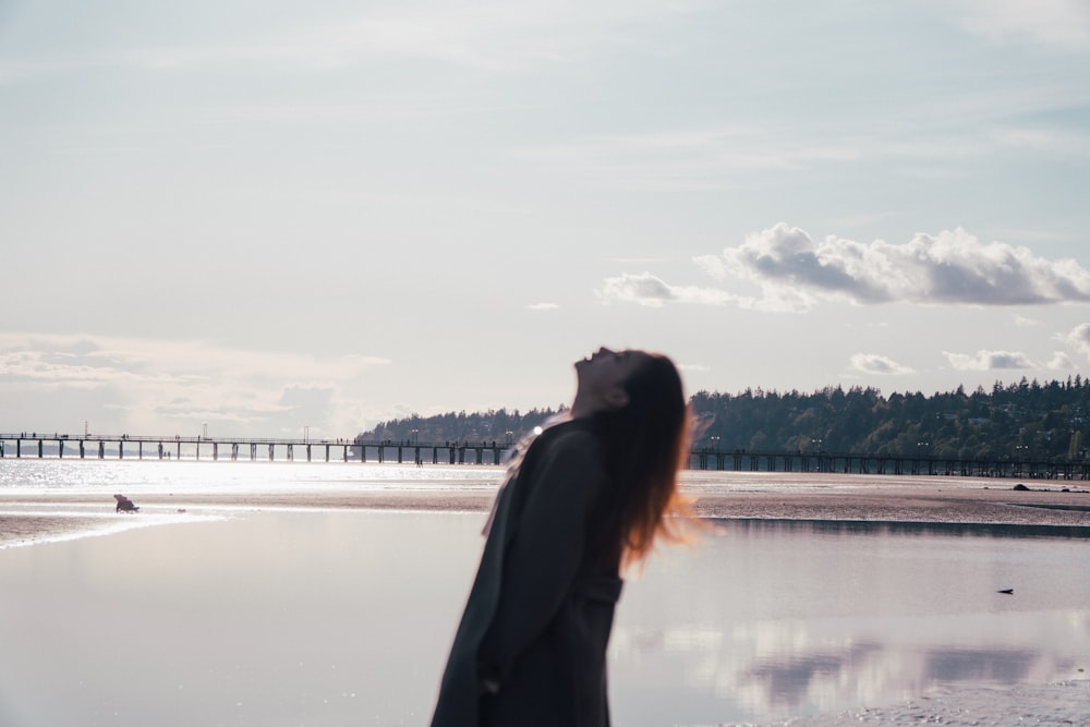 a person kissing on a beach