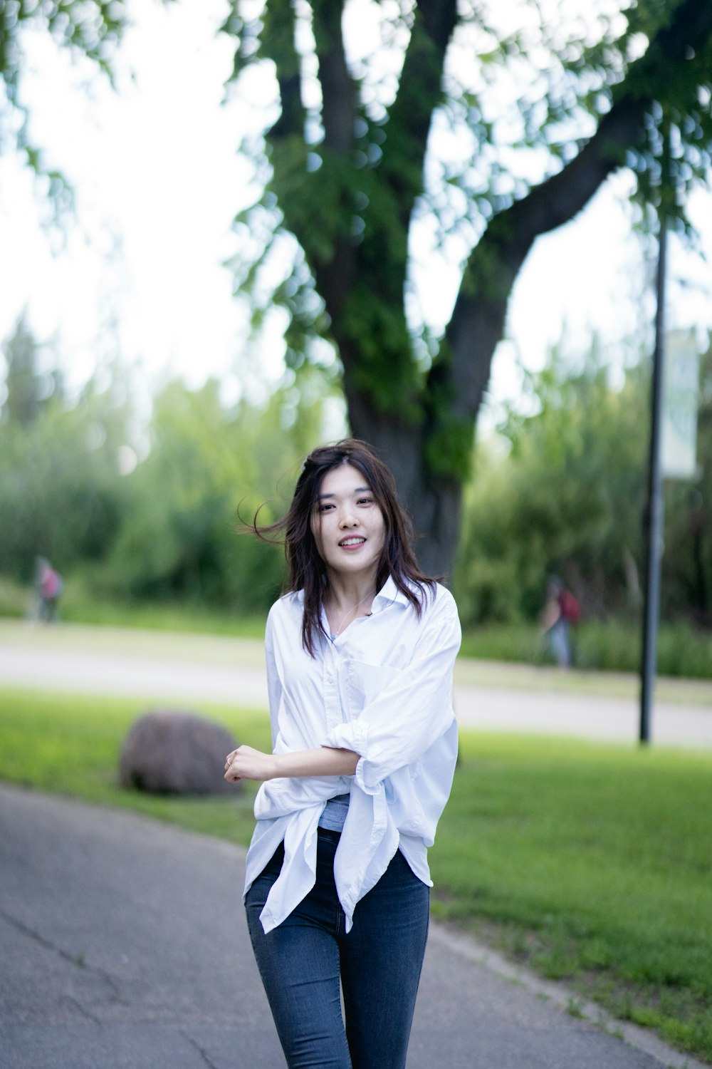 a woman standing on a sidewalk