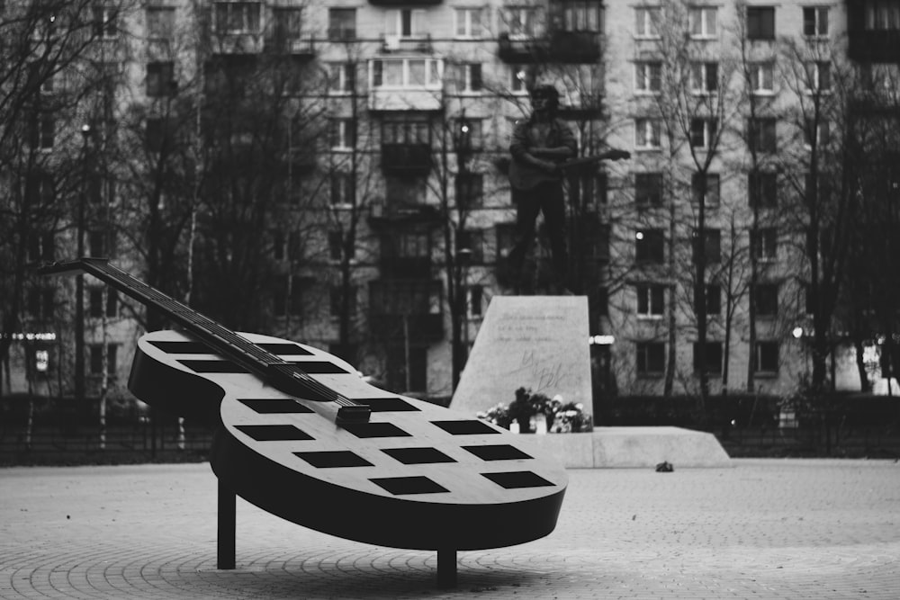 a sculpture of a person on a bench