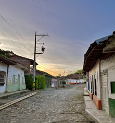 A rustic village street with colorful houses and cobblestones