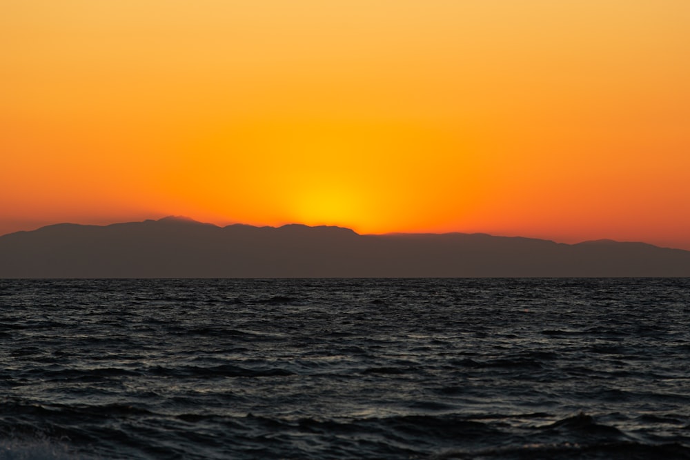 a body of water with mountains in the background