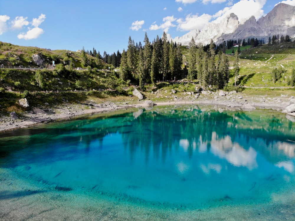 a lake with trees and mountains in the background