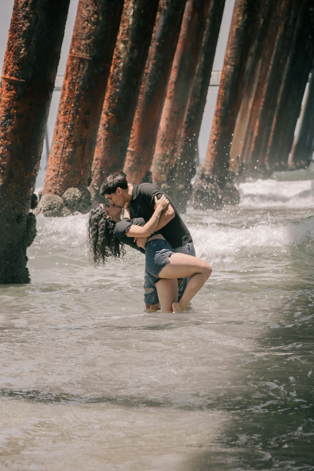 a man holding a woman in a river