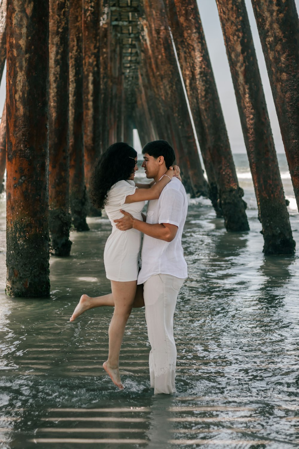 a man and woman kissing in water