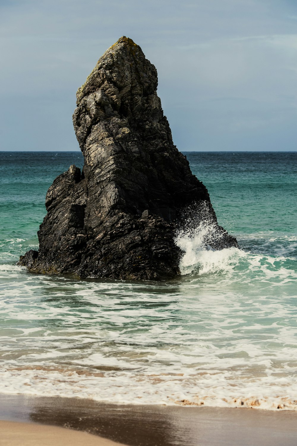 a large rock in the ocean