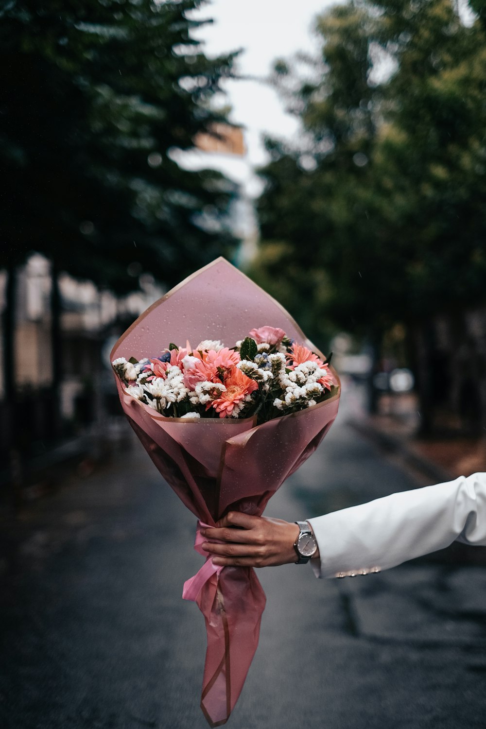 a person holding a bouquet of flowers