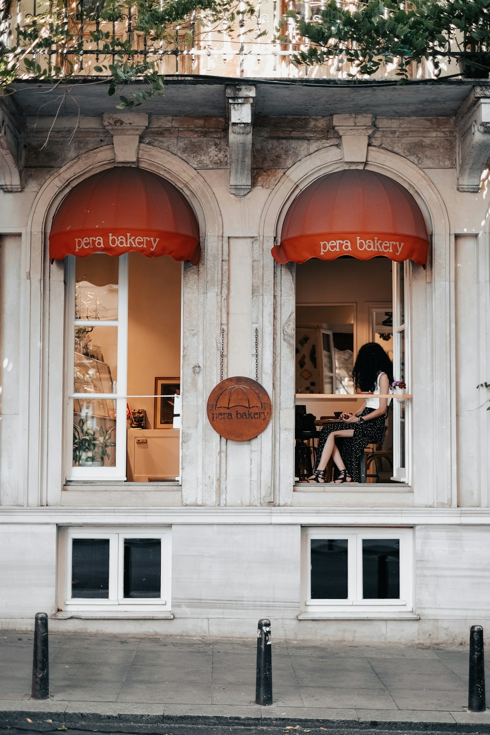 a person sitting at a table outside a building