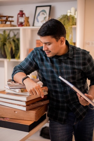 a man sitting on a stack of books