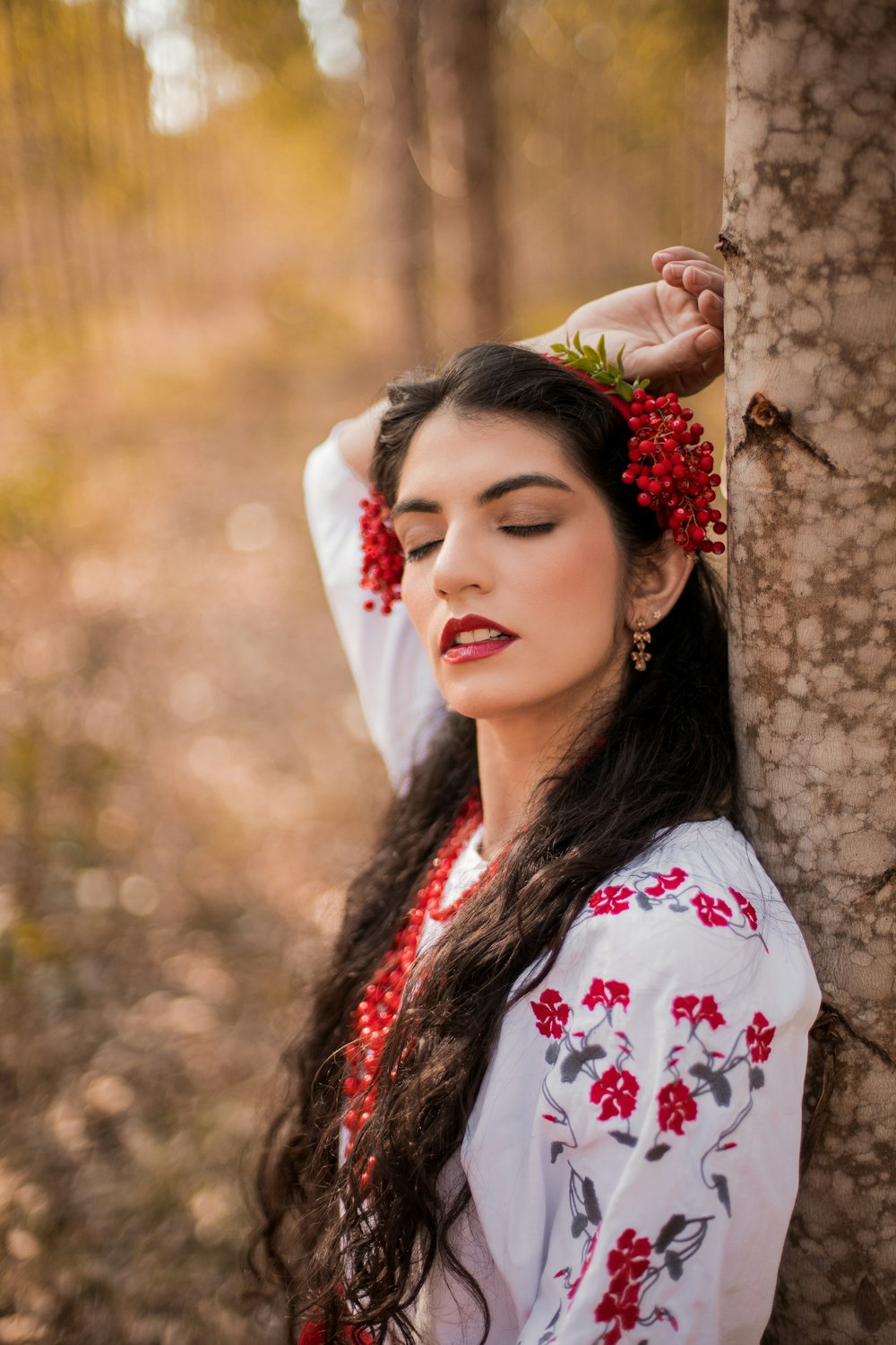 a woman wearing a headdress and holding her hand up