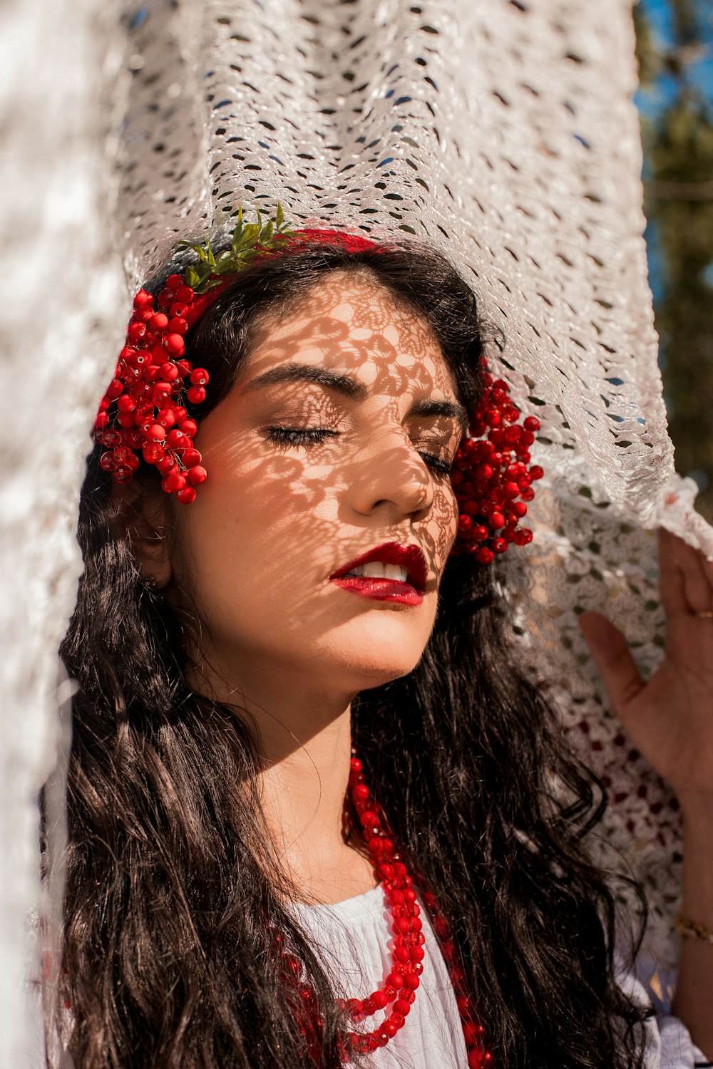 a woman with red flowers on her head