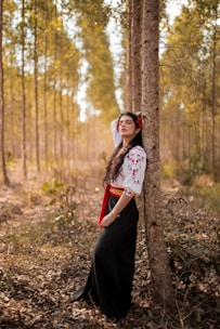 a person standing next to a tree