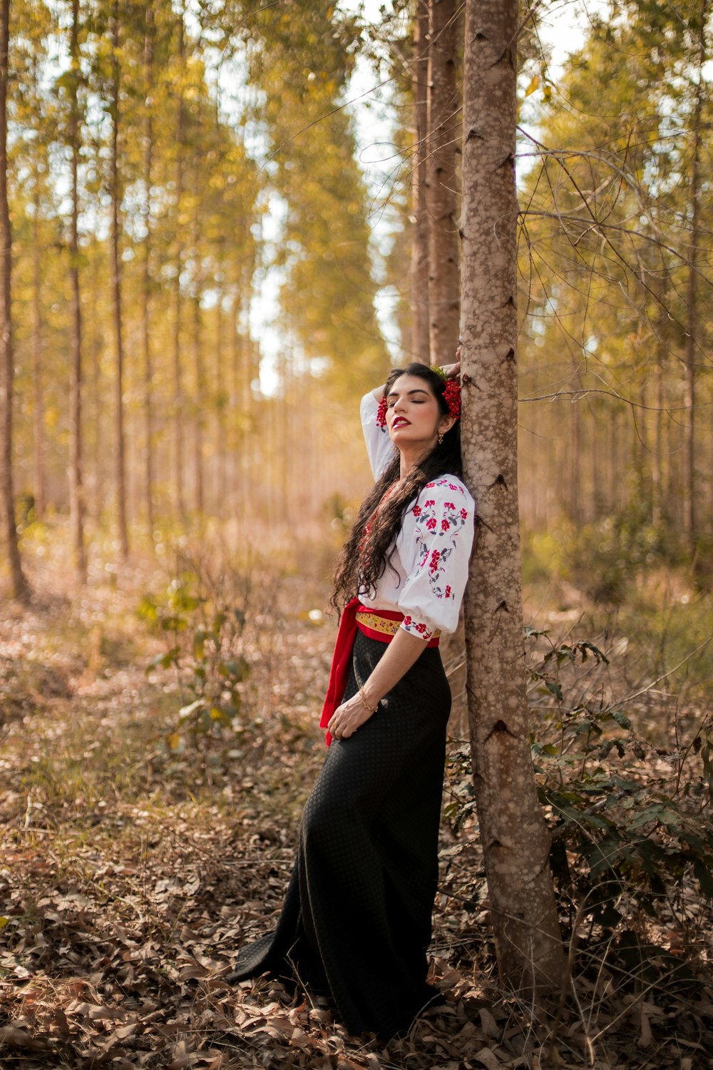 a person standing next to a tree