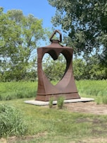 A heart-shaped sculpture in a vibrant city park.