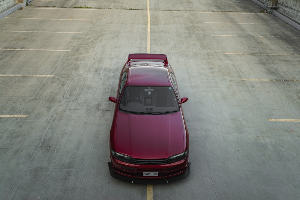 a red sports car parked on a paved area