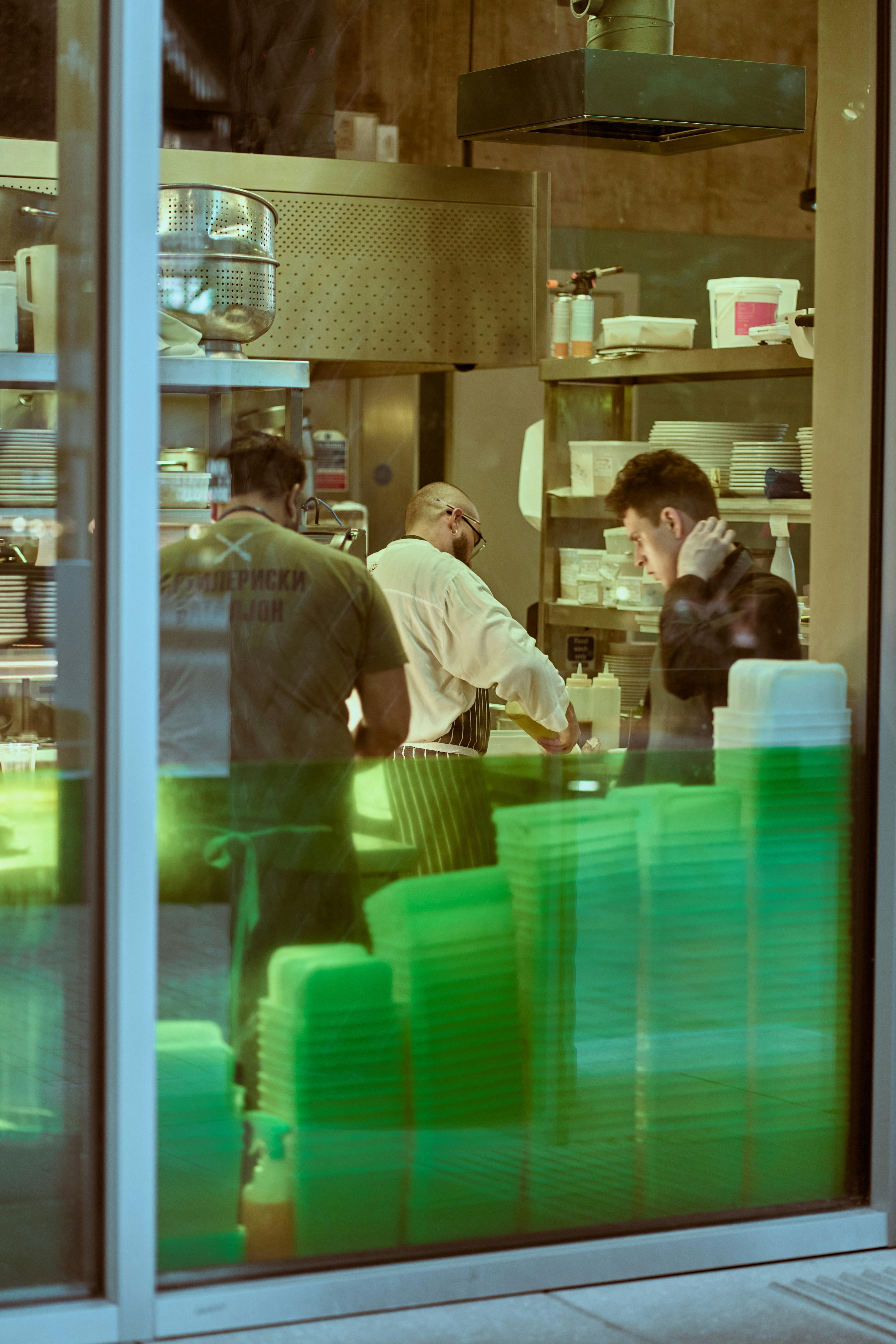 a group of people stand in a kitchen