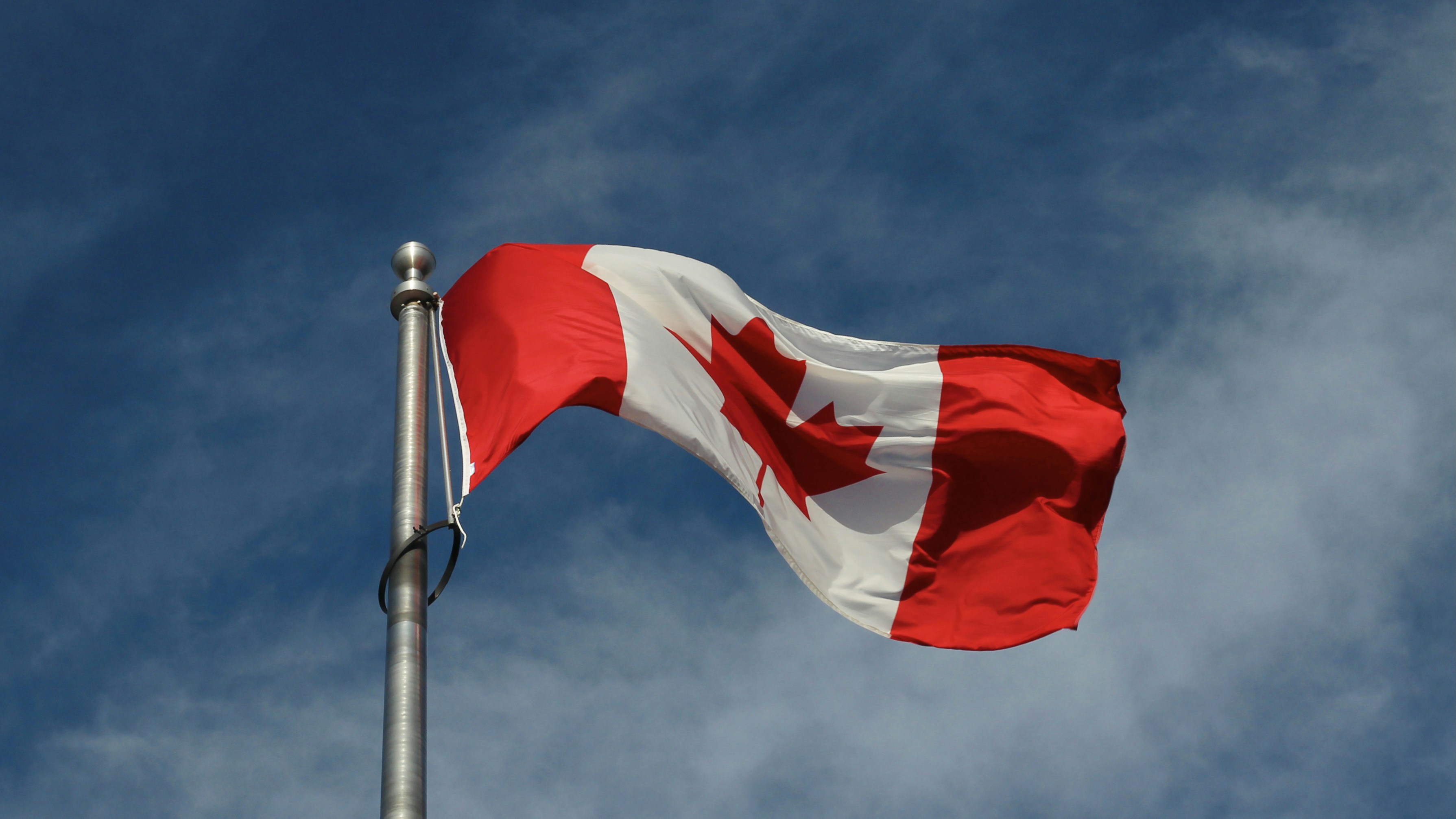 a red and white flag on a pole