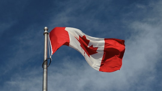 a red and white flag on a pole