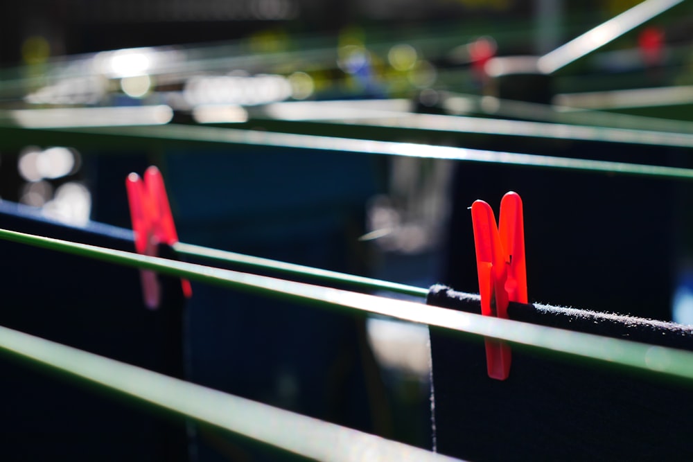 a pair of red socks on a green railing