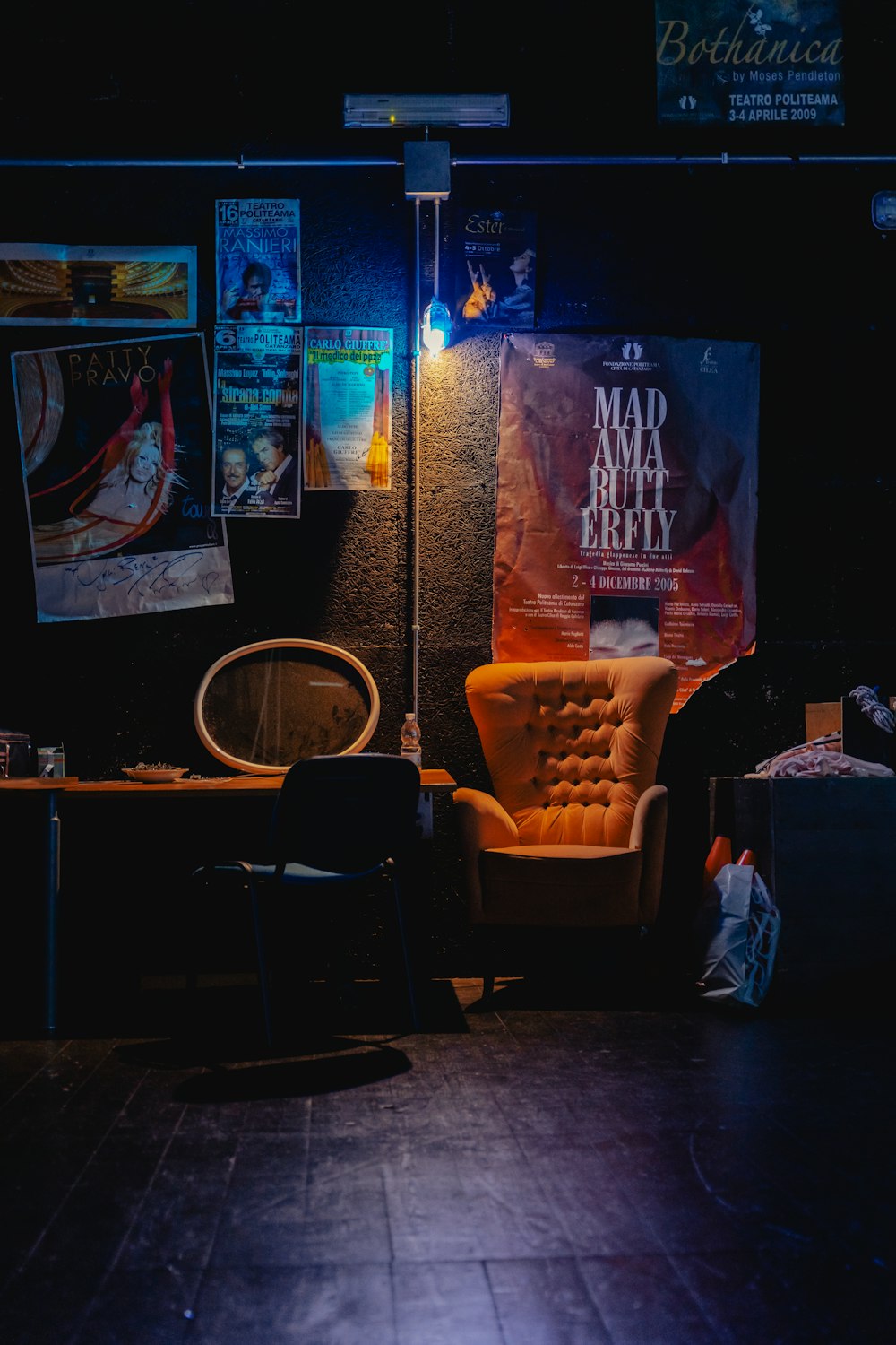 a room with a table chairs and a wall with posters on it