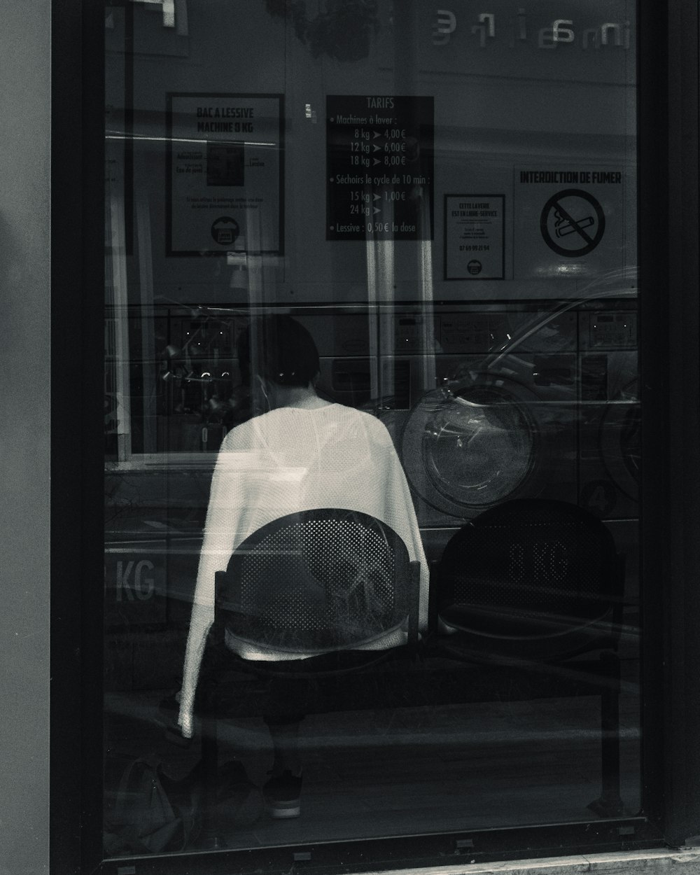 a person sitting in a glass window