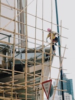 a few men climbing a ladder