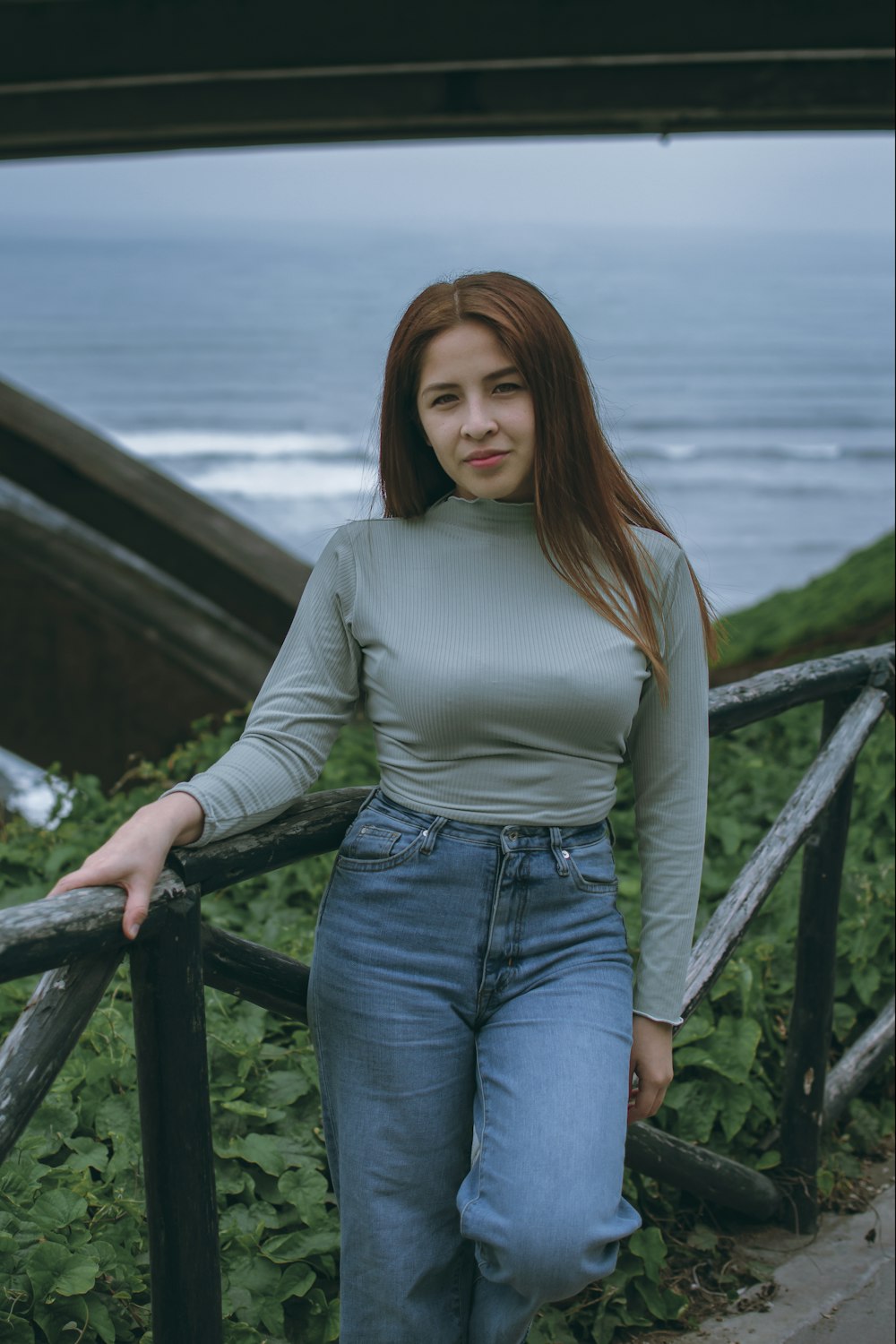 a woman leaning on a railing