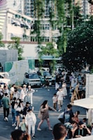 A lively outdoor event scene with people mingling near the Wildbites Streetfood food truck surrounded by lush greenery.