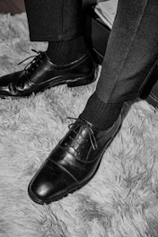 a pair of black shoes on a carpet