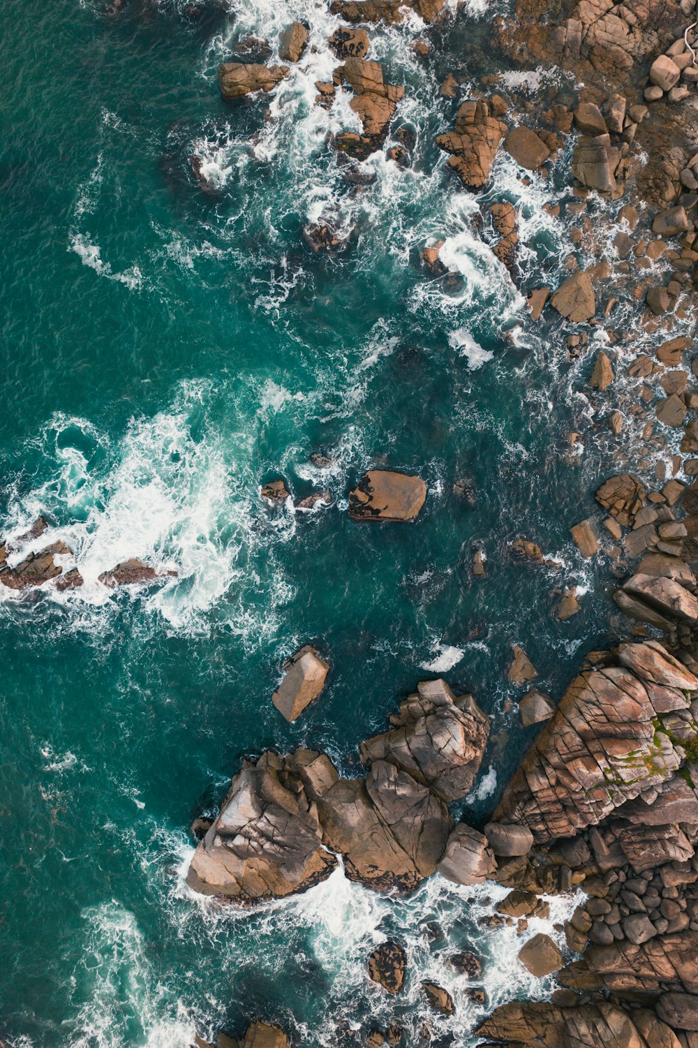 a rocky beach with waves crashing