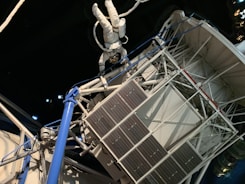 An astronaut conducting a spacewalk outside a spacecraft.