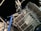 An astronaut in a white spacesuit floats outside a space structure, which appears intricate with panels and tubes. The background is a dark, starry space setting, emphasizing the feeling of being in outer space. The structure includes solar panels and metal trusses.