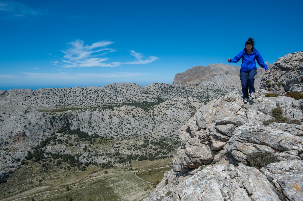 a man standing on a rocky hill