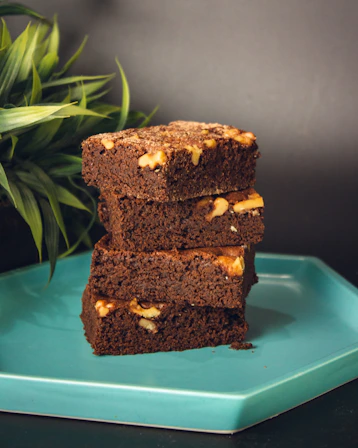 a brown cake with white frosting