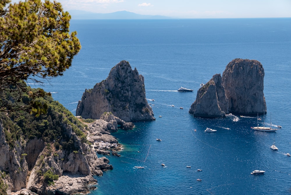 a rocky coast line with Faraglioni in the background