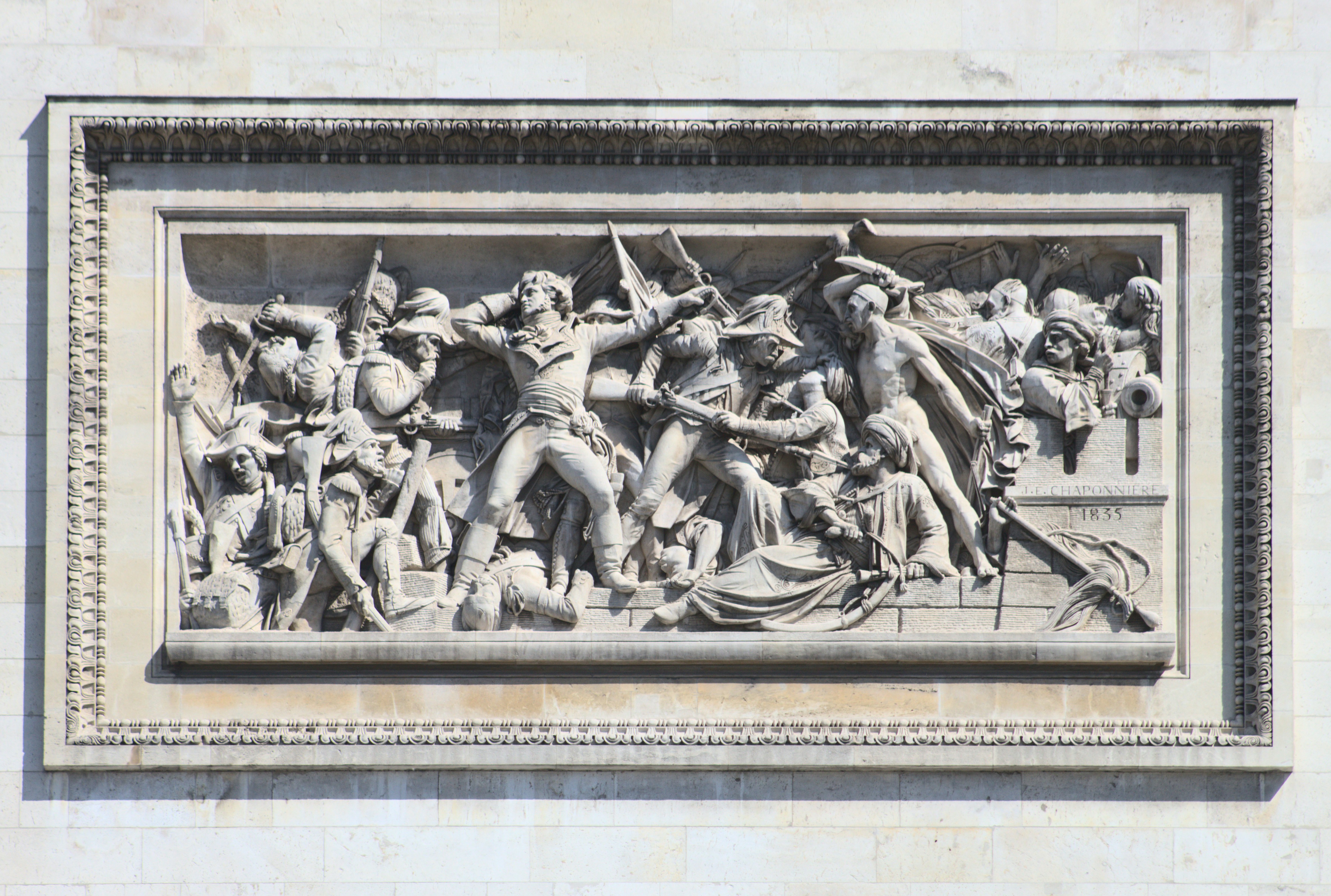 a stone sculpture of a group of people riding horses