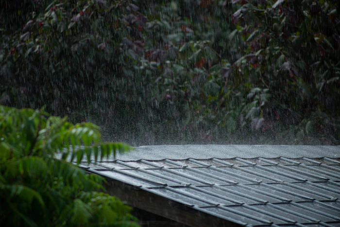 Heavy rain falling on a metal roof during a storm