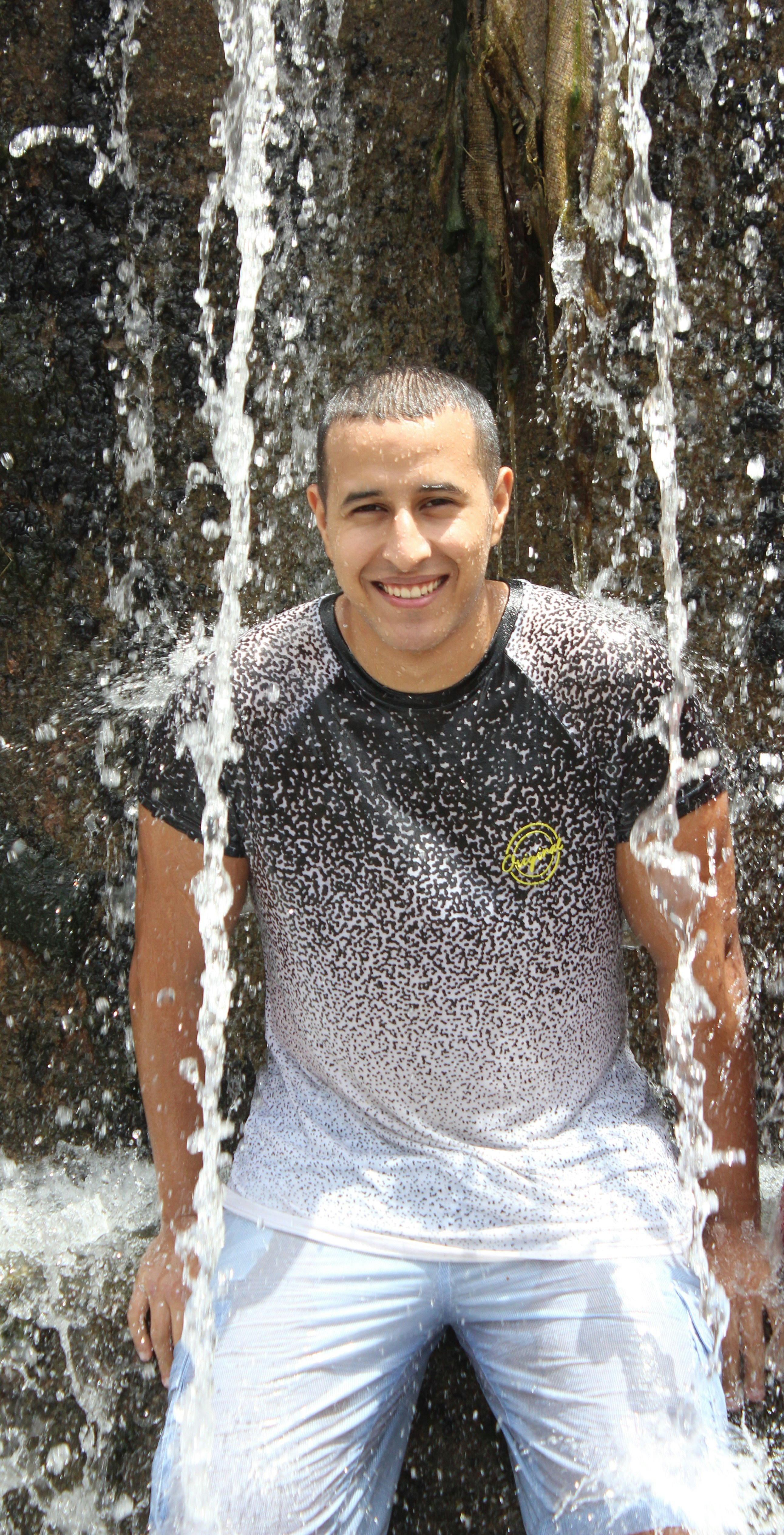 A man standing in front of a waterfall photo – Free Morocco Image on ...