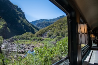 A scenic view from the window of Train A showcasing beautiful landscapes.