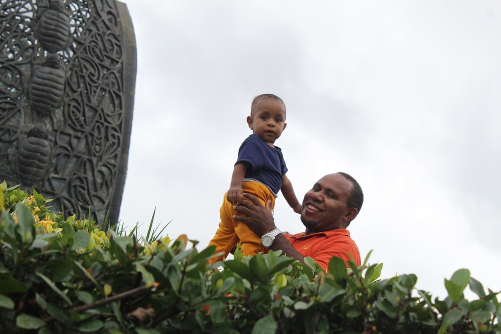 a man holding a baby